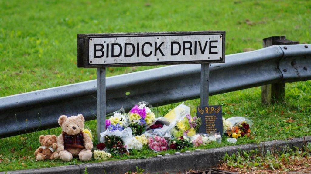 Biddick Drive sign with tributes underneath