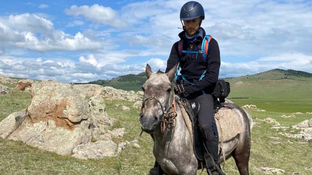 Dr Hames-Brown sitting on a horse in Mongolia