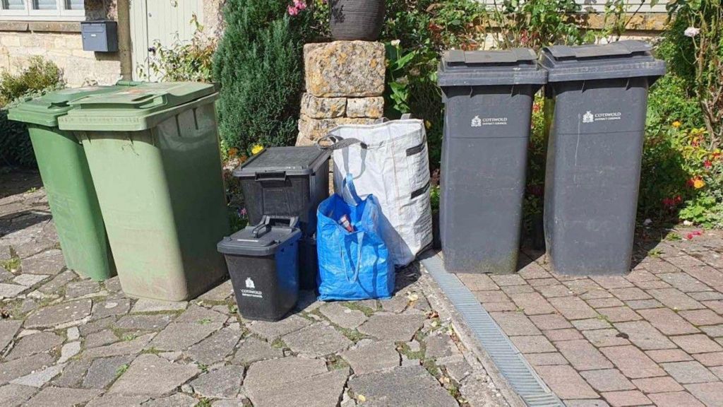 Garden, food, recycling and general waste bins lined up outside someone's house