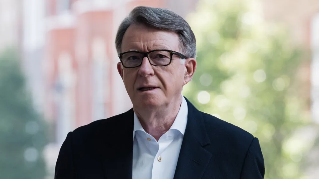 Lord Mandelson pictured outside wearing a blue shirt and dark blazer.