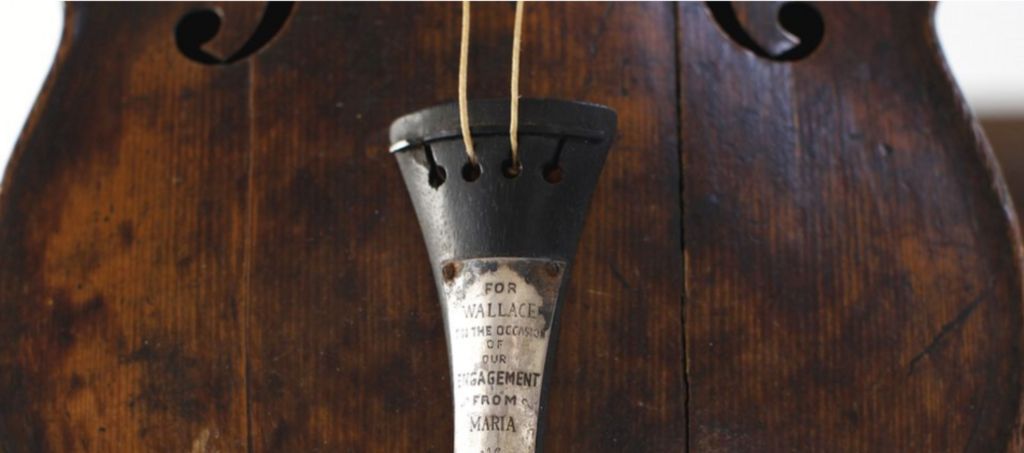 A close up of Wallace Hartley's violin with an inscription showing it was a gift from his fiance, Maria