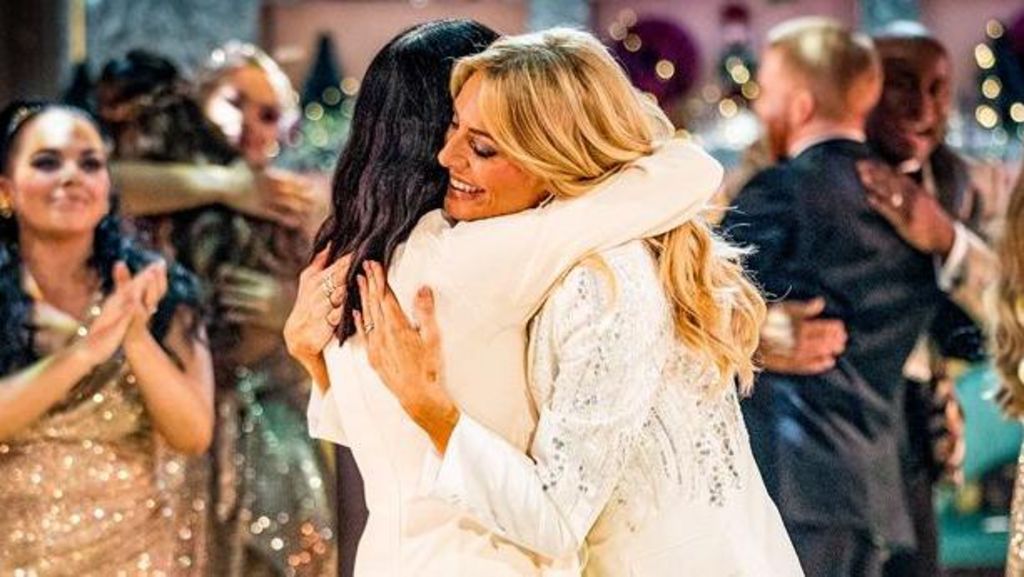 Strictly presenters Claudia Winkleman and Tess Daly share a hug on the dancefloor the end of their final show