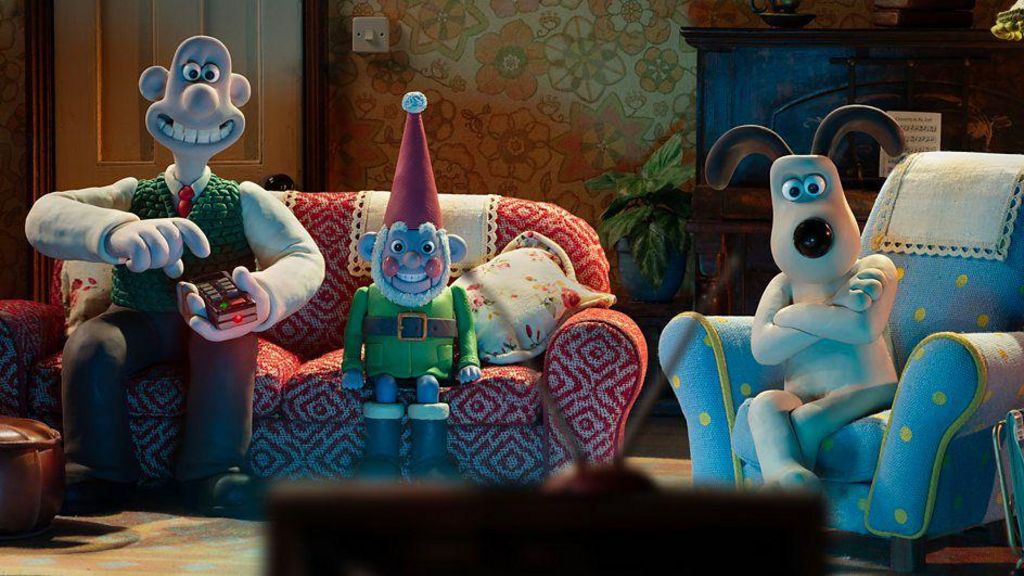 Wallace and Gromit characters sitting on a sofa in front of a television