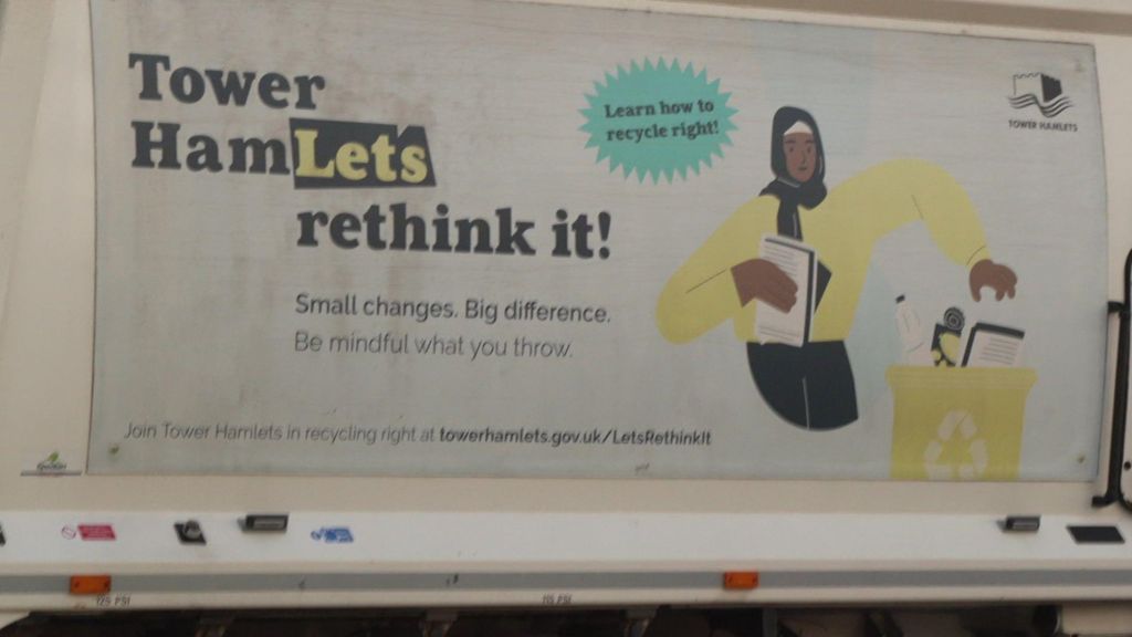 The side of the refuse lorry has a cartoon of a woman separating rubbish into recycling and no recycling