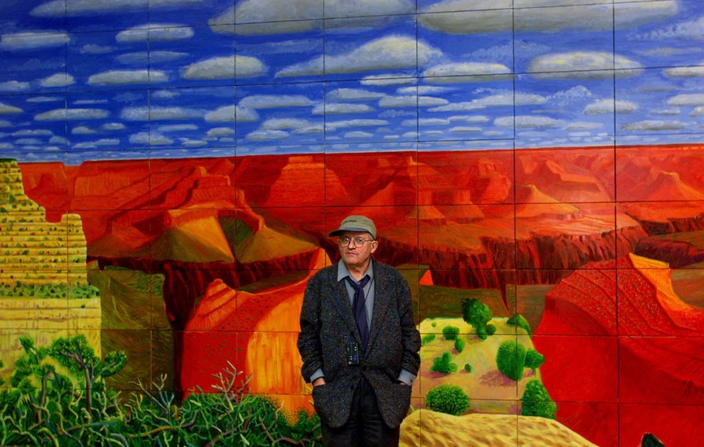 Hockney in front of one of his paintings, A Closer Grand Canyon, 1998