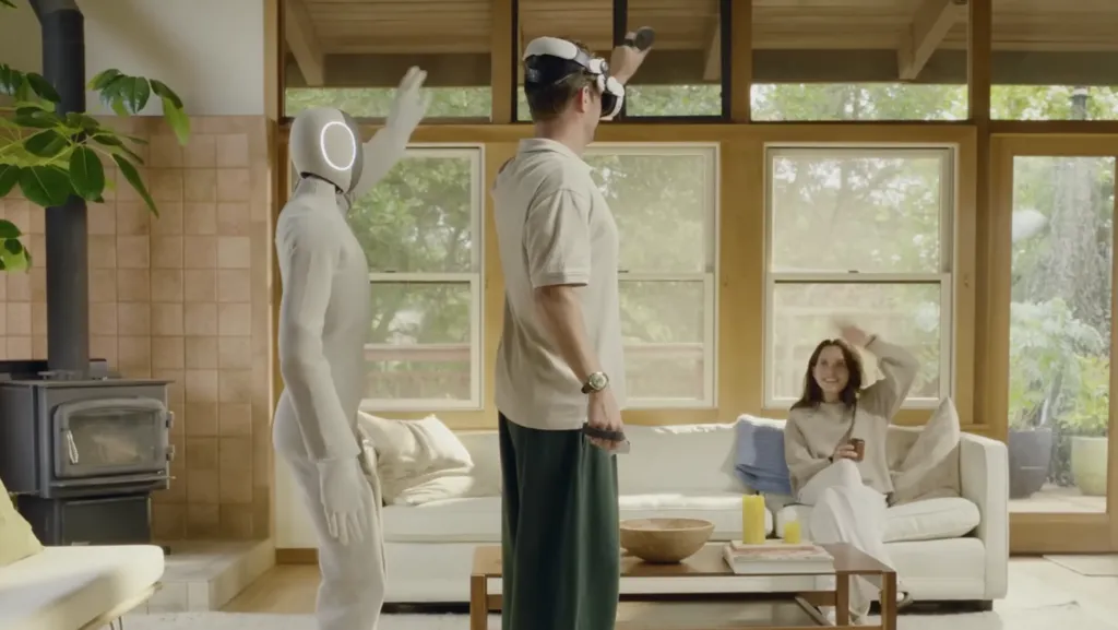 NEO the bot with a human wearing a VR headset. The robot follows how the human moves