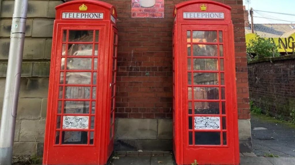 Two phone boxes with art dedicated to Hairy Biker Dave Myers and lighthouse keeper Peggy Braithwaite