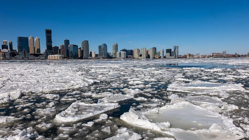 Ice floes are seen covering part of the Hudson River as skyscrapers are seen in the background along the Manhattan shoreline 