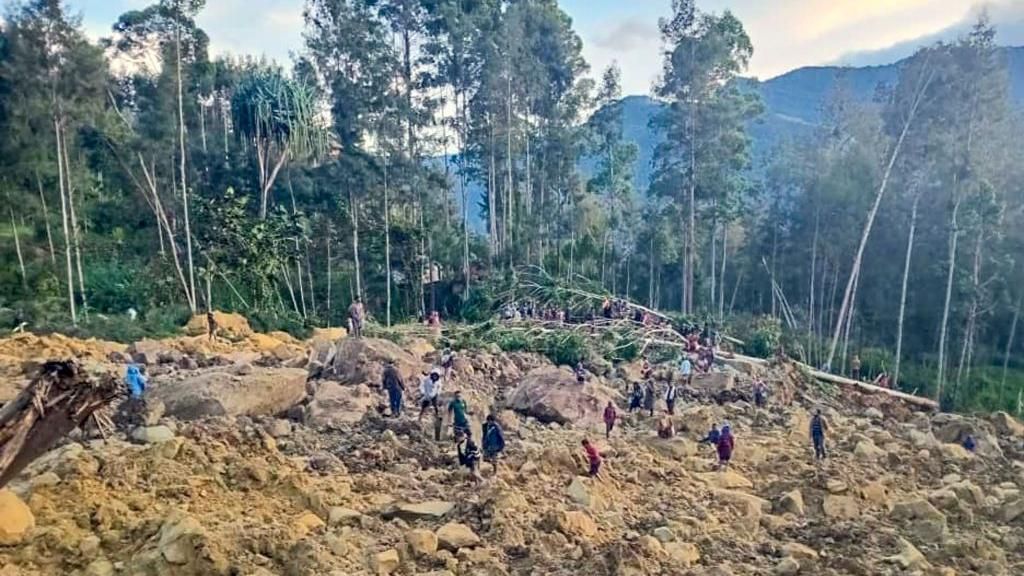 People gather at the site of a landslide in Maip Mulitaka in Papua New Guinea's Enga Province on May 24, 2024.