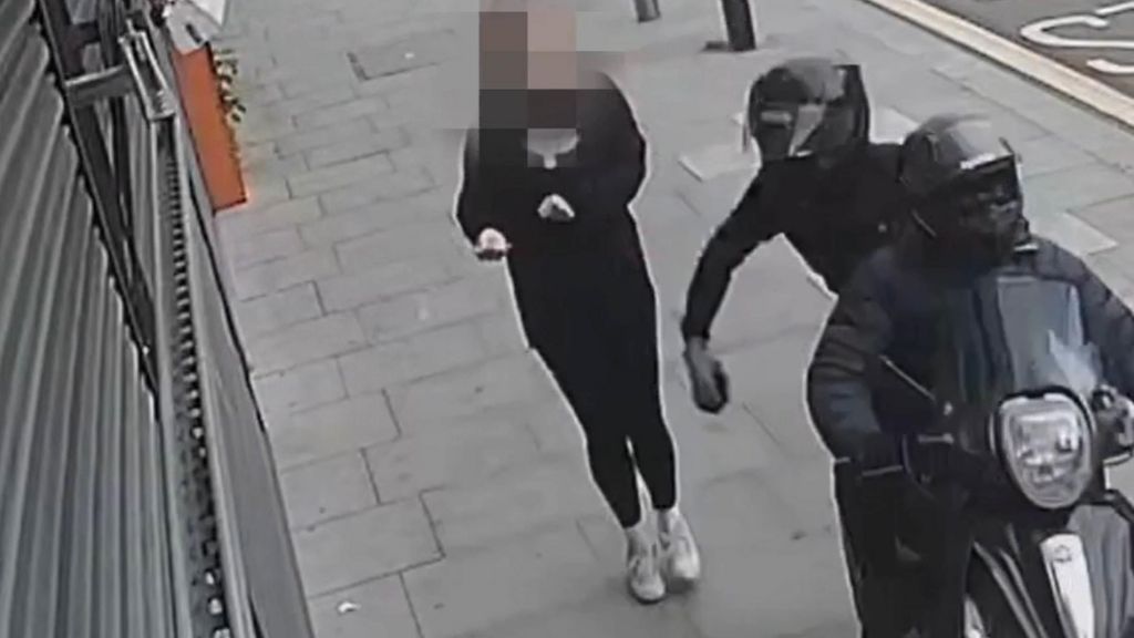 CCTV still shows two people on a moped appearing to attempt to steal a phone from a pedestrian on the pavement. 