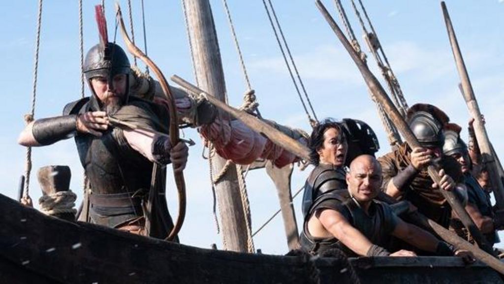 Matt Damon as Odysseus, firing a bow from a ship