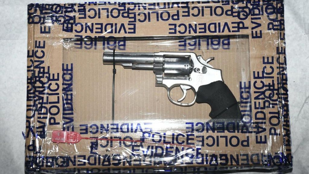 Gun wrapped in a box marked police evidence 