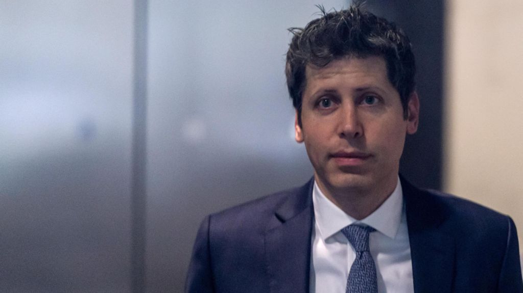 OpenAI CEO Sam Altman in the lobby of a federal courthouse in California wearing a navy suit jacket, blue necktie and white dress shirt.