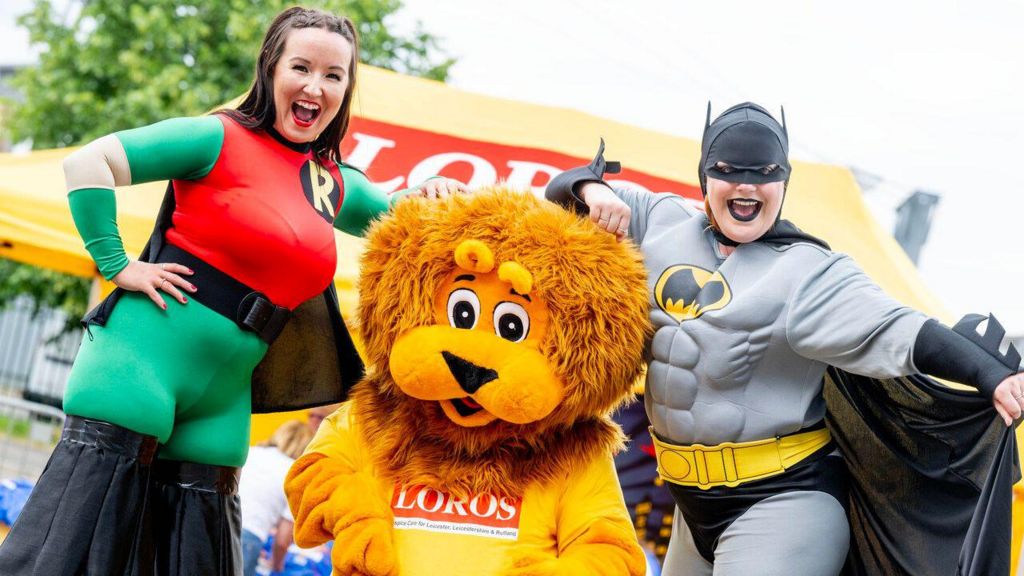 People dressed as Batman and Robin with a LOROS mascot