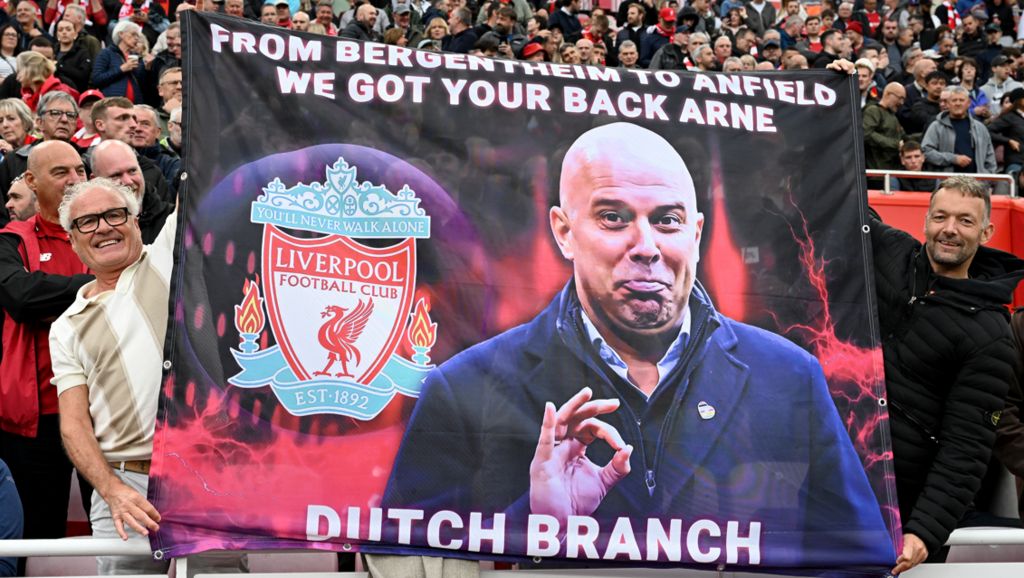 Liverpool fans hold up a banner before Arne Slot's first Premier League game at Anfield