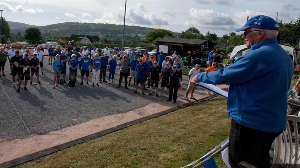 Members of the City of Bath club standing on the pistes listening to someone reading out results of a competition