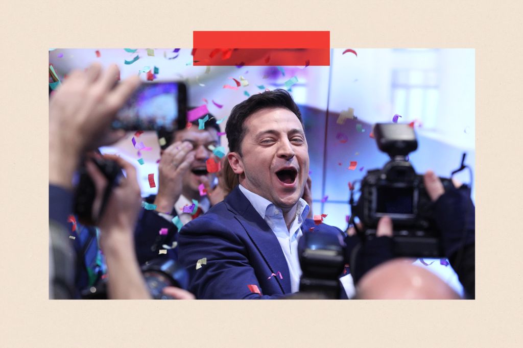 Volodymyr Zelenskiy smiles in a suit while confetti is in the air