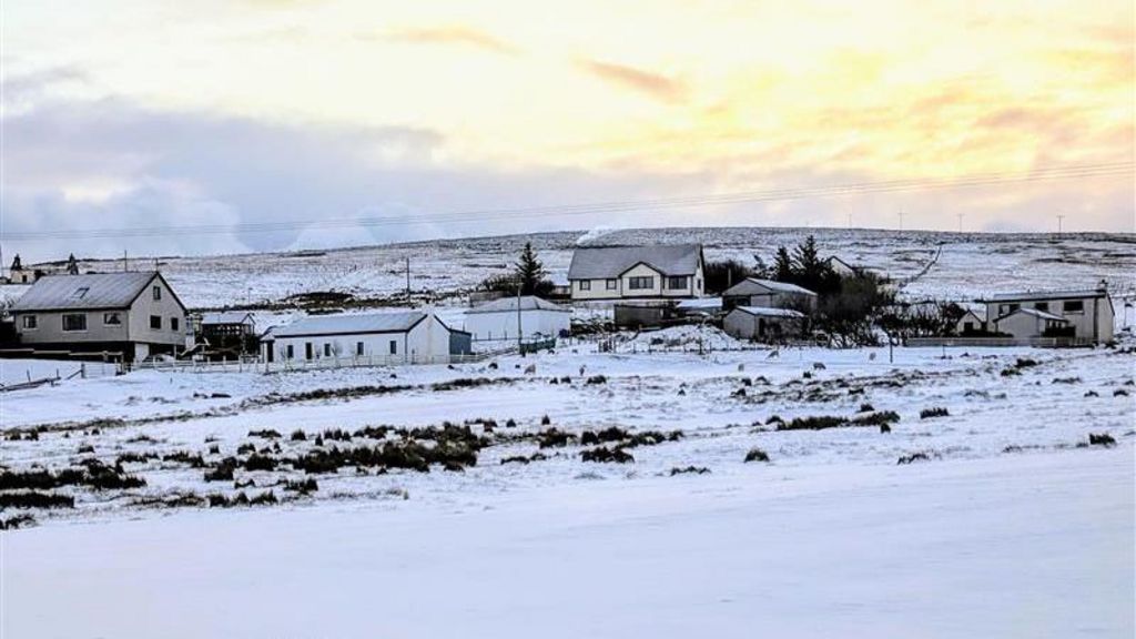 Buildings and fields covered by snow in the Shetland Isles