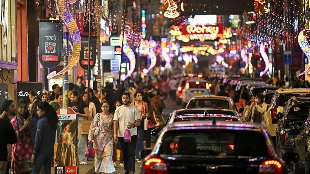 Shoppers walk along Commercial Street in Bengaluru city, illuminated with decorative lights ahead of New Year celebrations on 30 December, 2025. 

