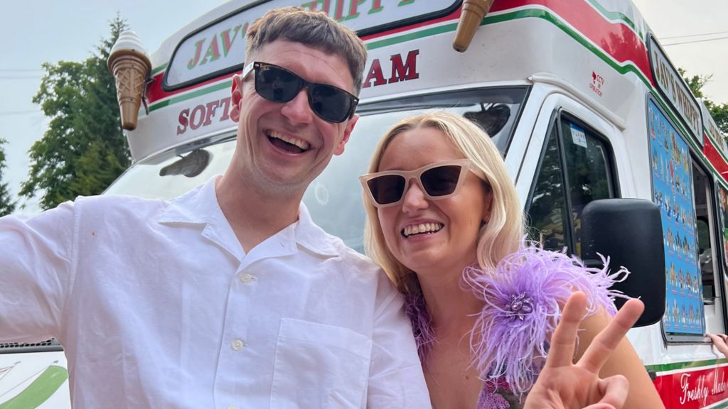 Ryan Losasso and Jade Beaty - they are both wearing sunglasses. Losasso is wearing a white shirt, Beaty has a feathery purple dress on.