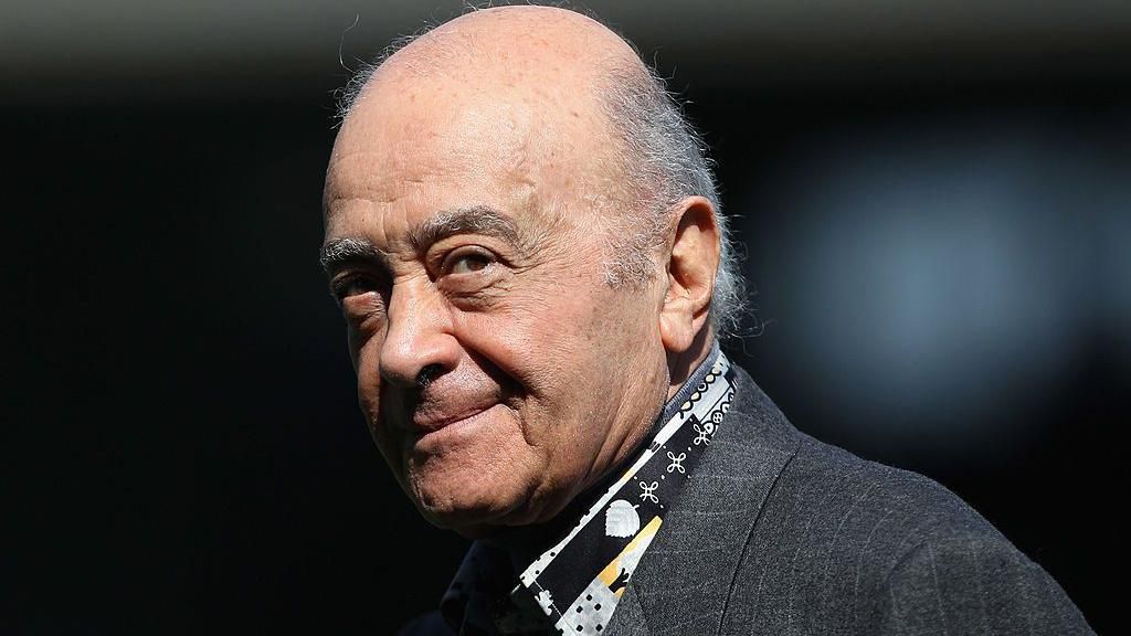 Mohamed Al Fayed is pictured at a football match wearing a grey suit jacket and a patterned black, grey and yellow shirt. He is balding with grey hair to the sides. At the time he was the Fulham chairman and is pictured ahead of the Barclays Premier League match between Fulham and Wolverhampton Wanderers at Craven Cottage on April 17, 2010 in London.