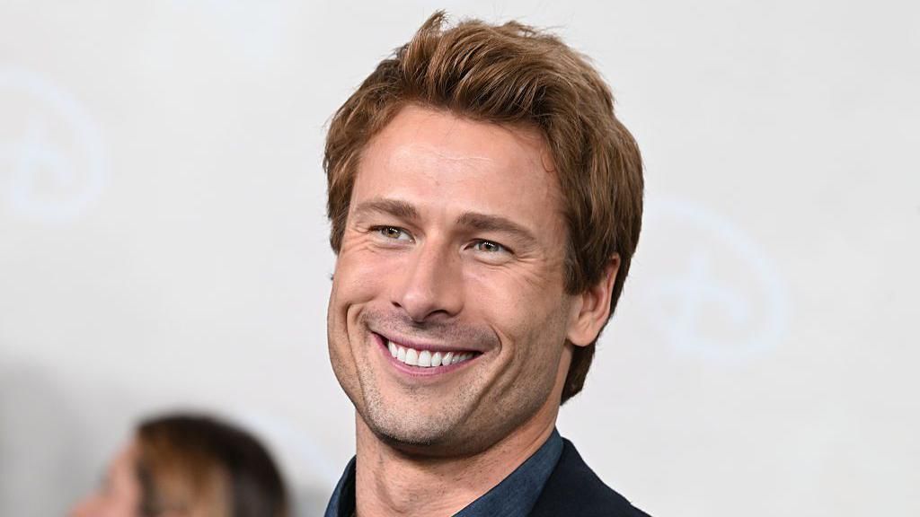A picture of Hollywood actor Glen Powell smiling
