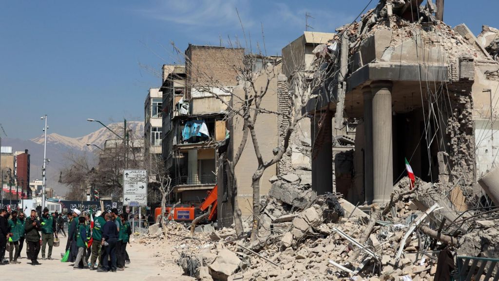 Iranians gather around a damage police station in central Tehran, Iran (4 March 2026)