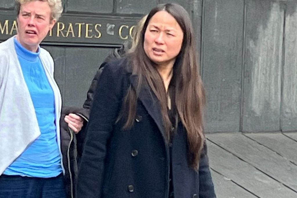Long-haired woman in navy peacoat next to a woman in blue top and light cardigan