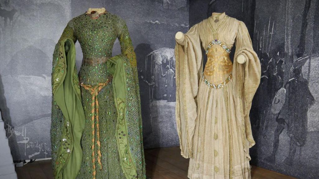 Beetle-wing dress and banqueting dress side by side on display at Smallhythe Place