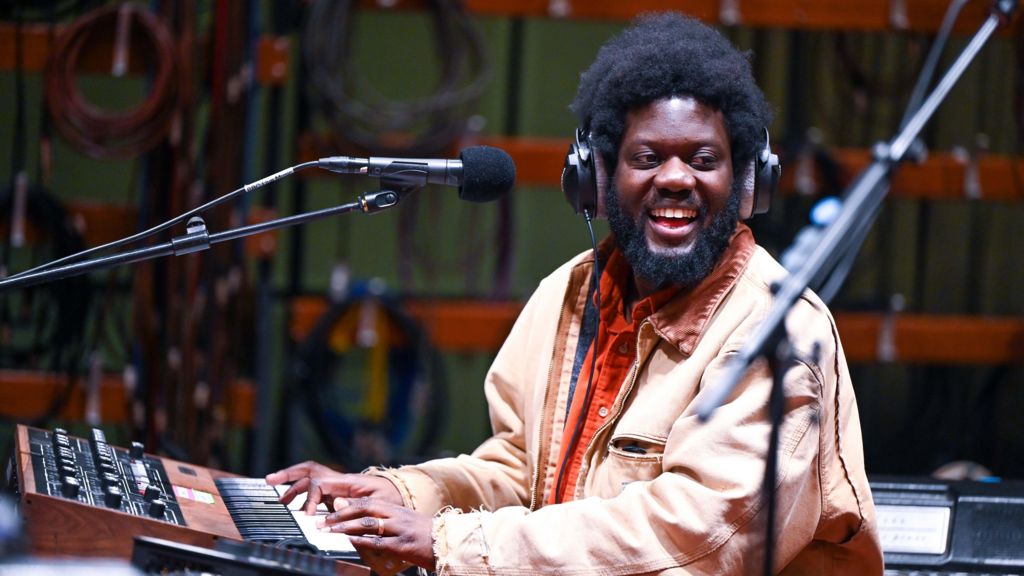 Michael Kiwanuka smiles as he plays a vintage keyboard during a session at the BBC's Maida Vale studios in November 2024.