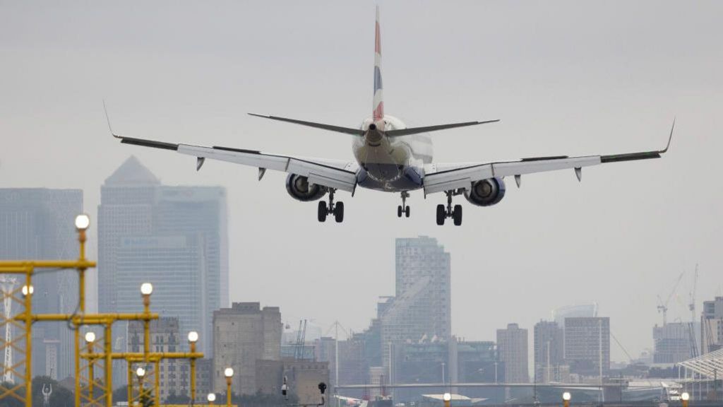 A plane lands at a London airport.