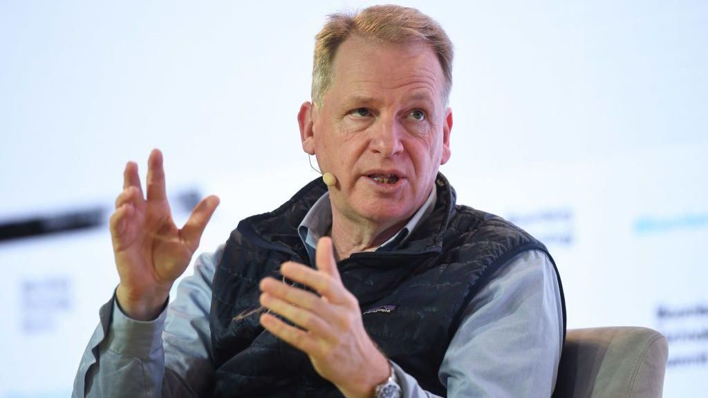 A middle-aged white man talking at an event in London