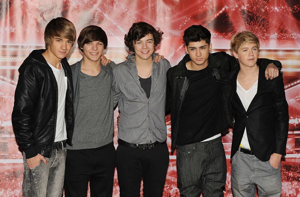 One Direction pose in front of The X Factor logo in December 2010