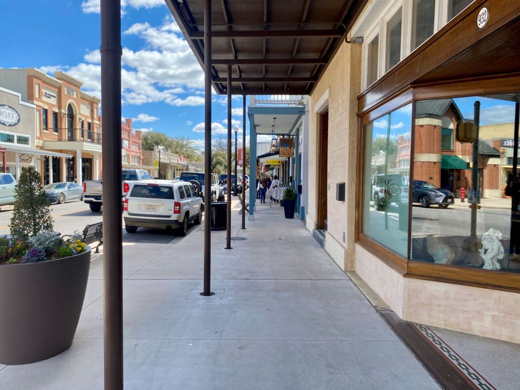 A view down the street of shops and a road surrounded by buildings that look typical of the American West