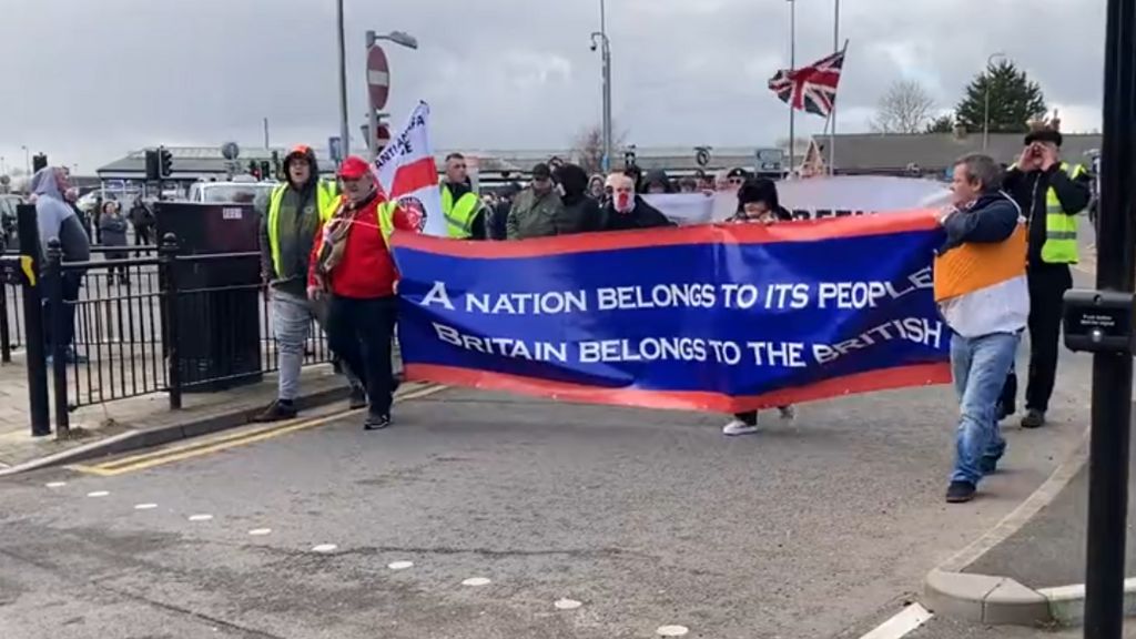 People holding a banner saying a nation belongs to its people 