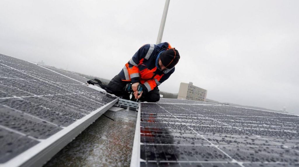 Solar panels being fitted on roof