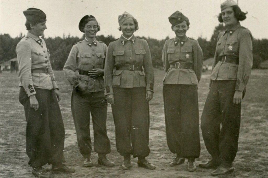 Black and white photo of Zo in Polish military uniform smiling with four other women in similar uniforms