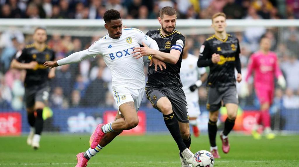 Leeds' Junior Firpo takes on Southampton's Jack Stephens