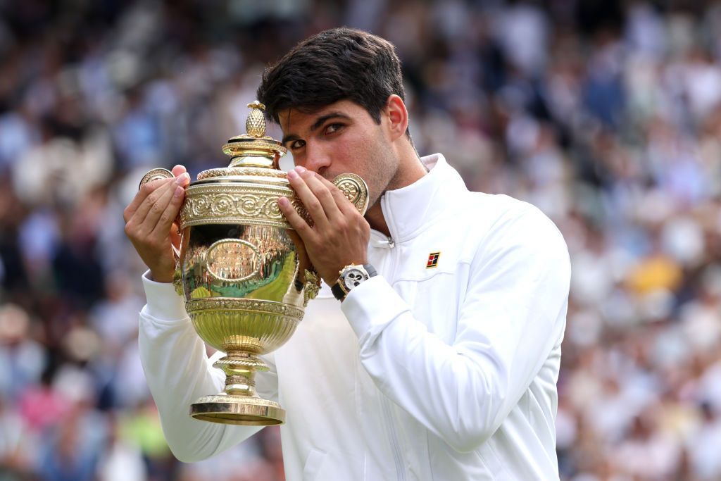 Novak Djokovic kisses the Wimbledon trophy