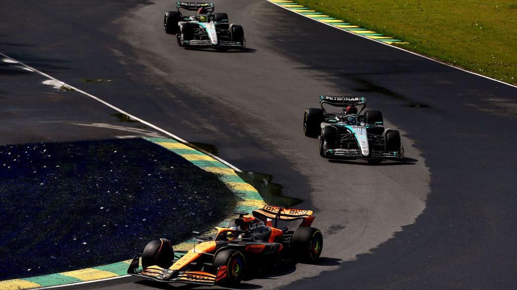 Oscar Piastri drives his McLaren in the Canadian Grand Prix with the Mercedes of George Russell and Lewis Hamilton following him