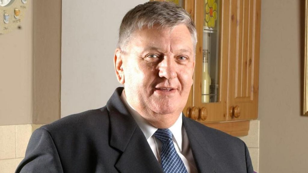 The actor Derek Martin wears a suit and tie.