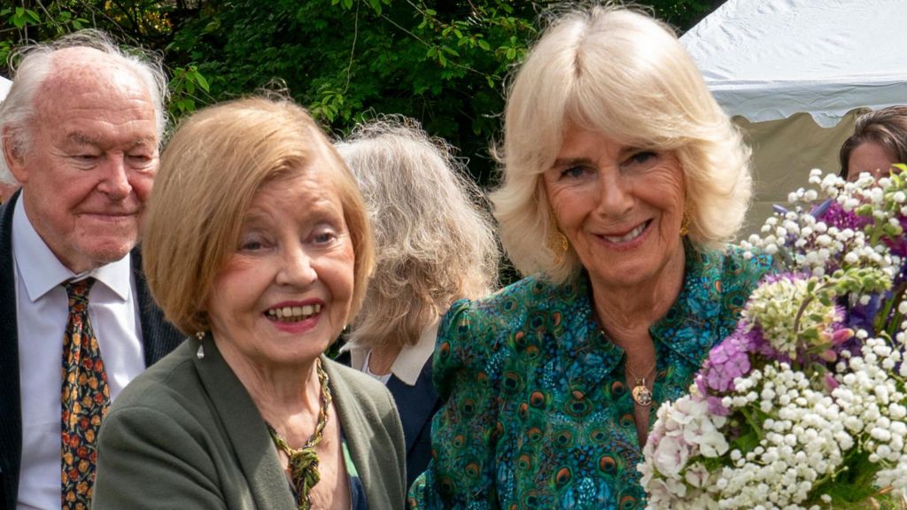 Prunella Scales, with husband Timothy West in the background, alongside Queen Camilla, at a garden party in Rye last year.