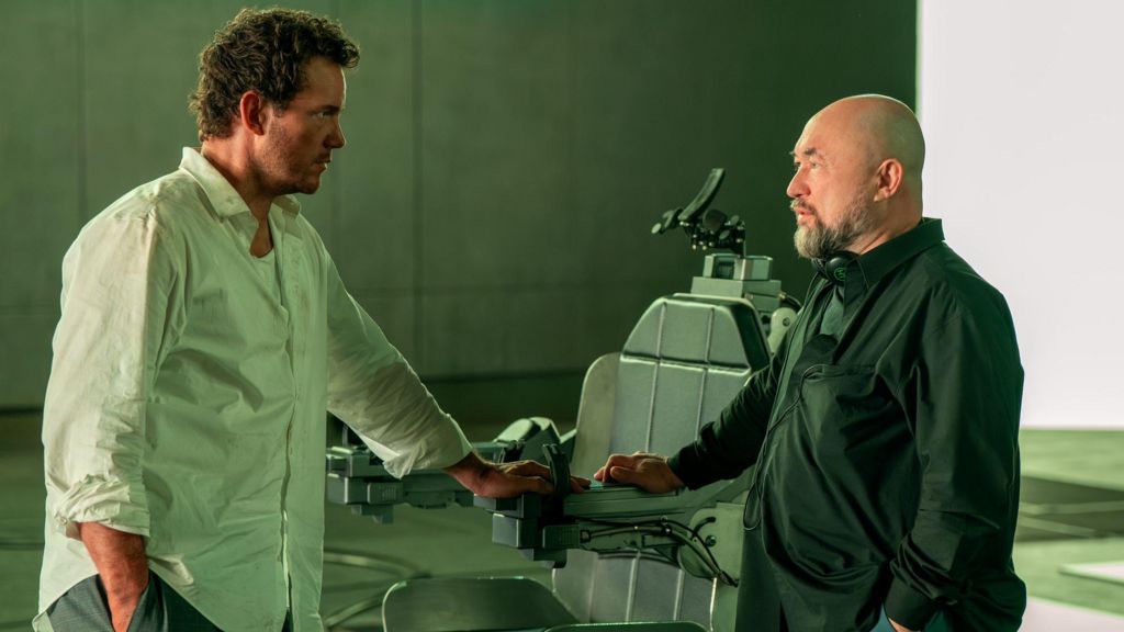 Chris Pratt and director Timur Bekmambetov on set, next to the chair Pratt was locked into during filming