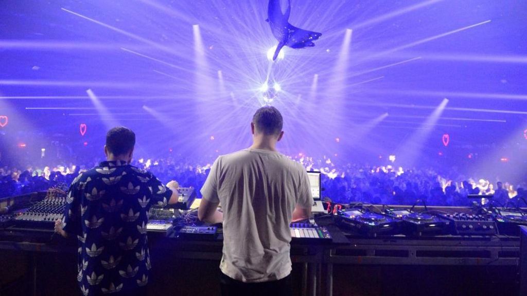 Bicep performing on stage in California with a light display and dancing fans