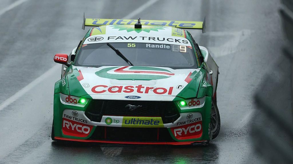 A green Ford racing car with a Castrol sponsorship logo on the bonnet.