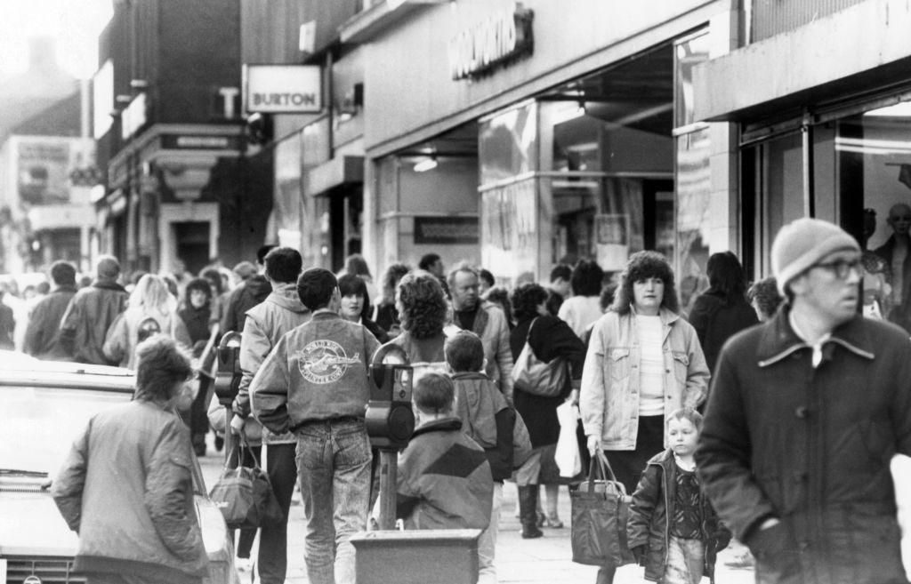A black and white photo of Gateshead High Street in December 1988, looking bustling with a crowd of shoppers