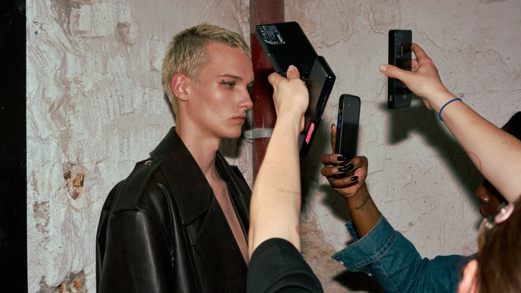 A model poses backstage at the System SS25 show