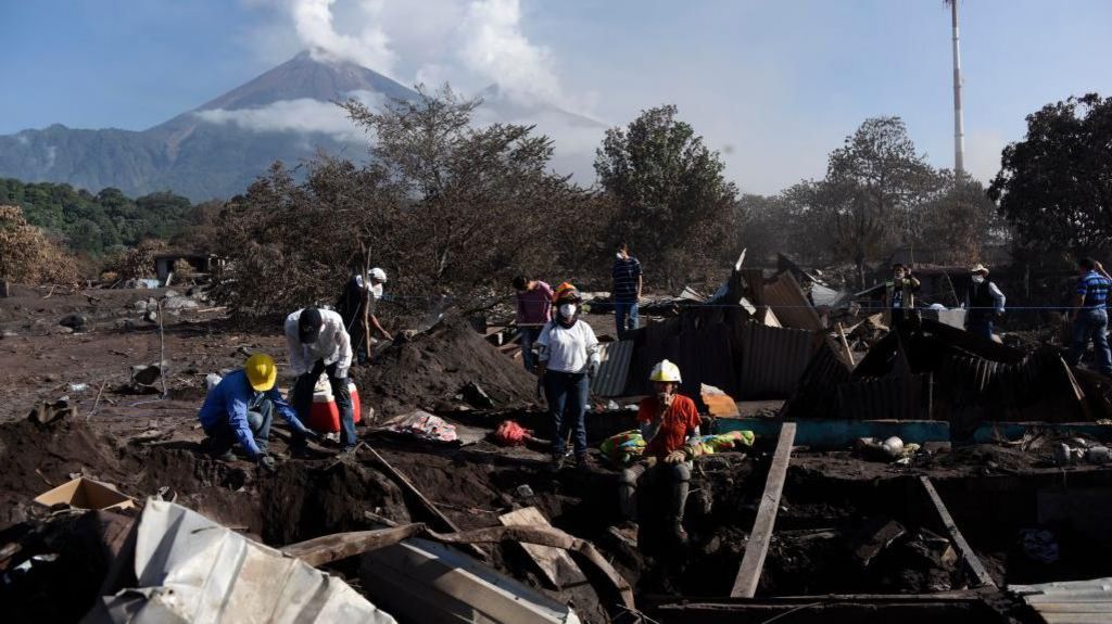 Locals search through the remnants of San Miguel Los Lotes, which was buried under ash and rock