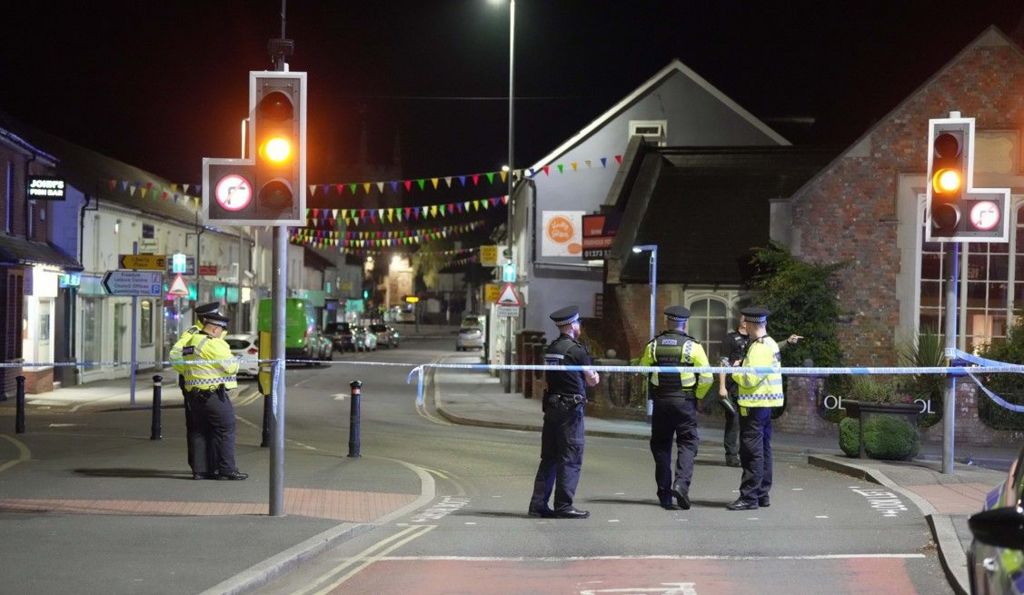 The town centre at night with police tape and several police officers