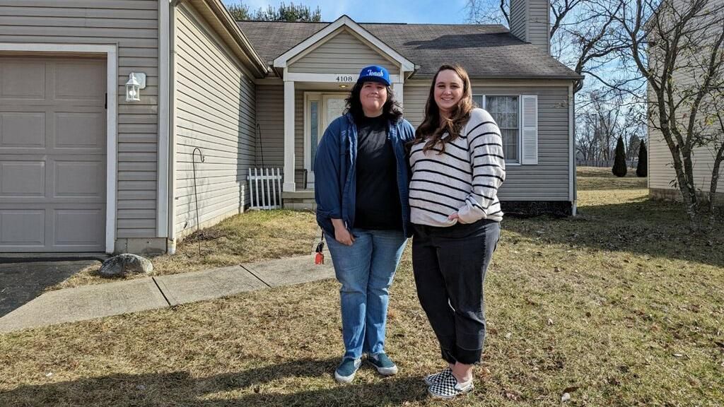 Megan Holter and her wife Sonia outside their new home in Columbus